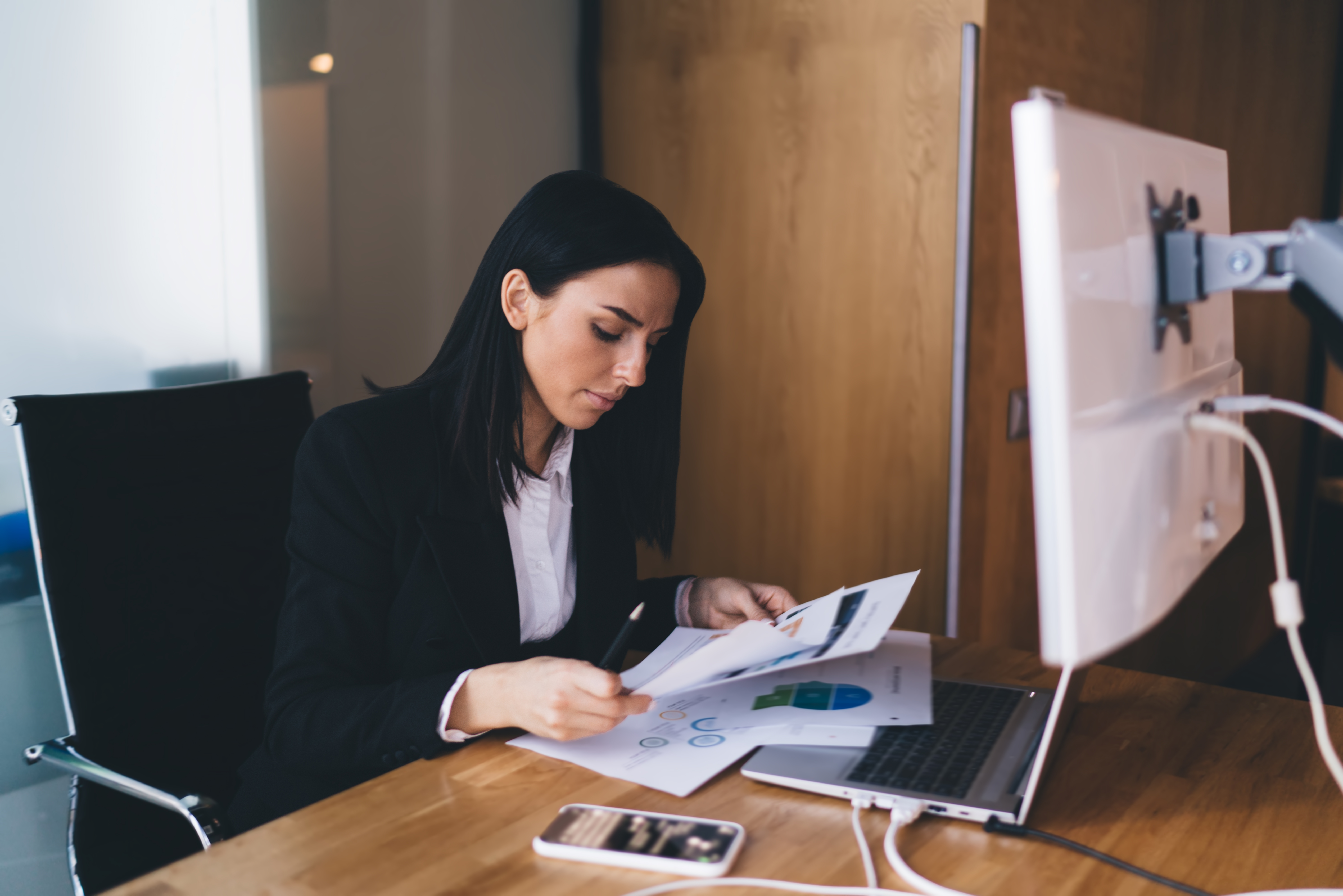 Confident woman working on project in office