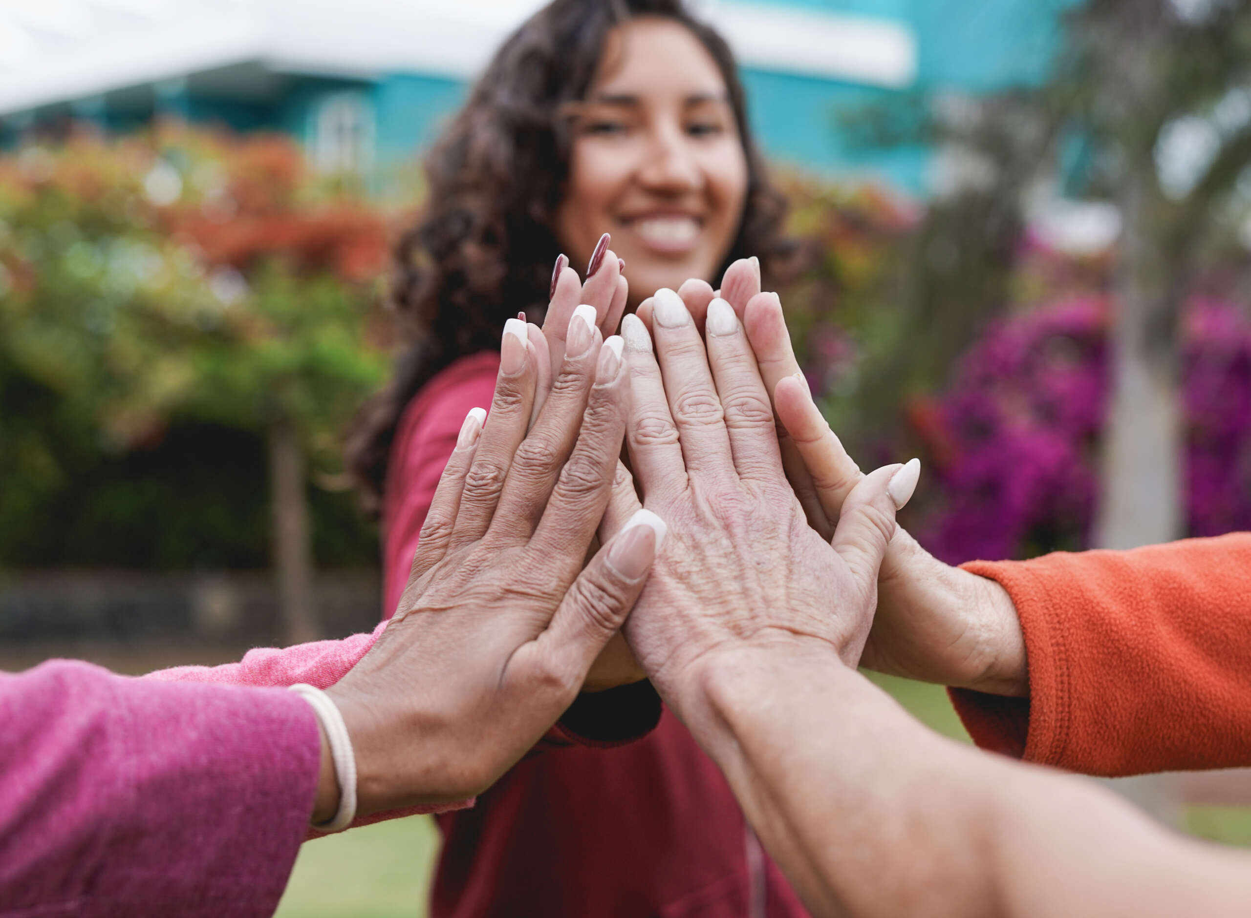 Stracking hands of multiracial women – Multi generational people